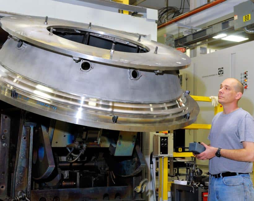 EB Weld Operator Examining Large Weld Application on Rotary Table