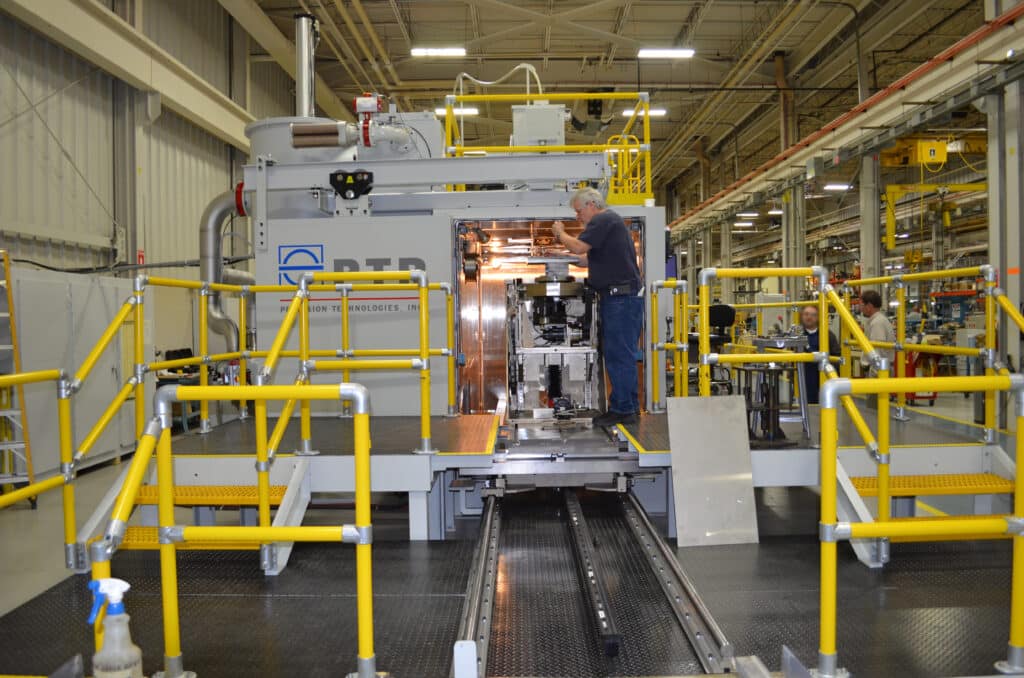 PTR Electron Beam Welding Operator Examining Part on Rotary Positioner
